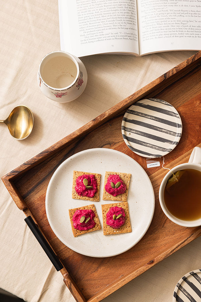 Homemade wholewheat crackers served with a creamy beetroot dip